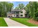 Well-manicured lawn and tasteful landscaping accentuates this modern two-story home with a three-car garage at 130 Nova Ln, Roswell, GA 30075