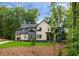 Beautiful new construction with three-car garage, board and batten siding, professional landscaping, and mature trees at 130 Nova Ln, Roswell, GA 30075