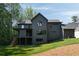Contemporary home exterior with a spacious deck, modern design elements, and beautifully landscaped surroundings at 130 Nova Ln, Roswell, GA 30075