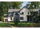 Modern two-story home with a combination of light and dark siding and well-maintained lawn at 130 Nova Ln, Roswell, GA 30075