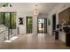 Bright foyer with staircase, hardwood floors, chandelier, and black framed windows providing natural light at 130 Nova Ln, Roswell, GA 30075