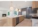 Open concept kitchen with stainless appliances, a marble island, and access to the living room at 130 Nova Ln, Roswell, GA 30075