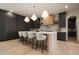 Spacious kitchen featuring a large island with seating, dark cabinets, and modern appliances at 130 Nova Ln, Roswell, GA 30075