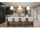 Modern kitchen with dark cabinetry, a marble backsplash, a large island, and pendant lighting at 130 Nova Ln, Roswell, GA 30075