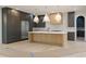 Modern kitchen with custom wood cabinets, stainless steel appliances, and a large marble countertop island at 130 Nova Ln, Roswell, GA 30075