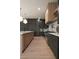 A modern kitchen features stainless steel appliances and a center island with marble countertops at 130 Nova Ln, Roswell, GA 30075