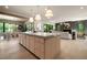 Open floor plan showcasing the kitchen island with seating and views to the dining and living areas at 130 Nova Ln, Roswell, GA 30075