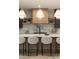 Bright, modern kitchen featuring stainless steel appliances, island, and stylish pendant lighting at 130 Nova Ln, Roswell, GA 30075