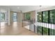 Upstairs landing with black metal banister, large windows, and views of the surrounding trees at 130 Nova Ln, Roswell, GA 30075