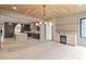 Open-concept living space featuring a wet bar, decorative chandelier, and access to a modern kitchen at 130 Nova Ln, Roswell, GA 30075
