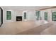 Bright and spacious living room with modern fireplace, large windows, and beautiful hardwood floors at 130 Nova Ln, Roswell, GA 30075