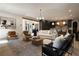 Open-concept living room featuring stylish furniture, modern lighting, and hardwood floors at 130 Nova Ln, Roswell, GA 30075