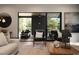 Cozy living room with a large sliding glass door to the outdoor living area and contemporary decor at 130 Nova Ln, Roswell, GA 30075
