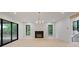 Spacious living room with fireplace, modern lighting, wood floors, and access to outdoor living space at 130 Nova Ln, Roswell, GA 30075
