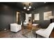 Stylish office with dark walls, modern lighting, hardwood floors and comfortable seating area at 130 Nova Ln, Roswell, GA 30075