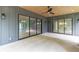Inviting covered porch with stylish lighting fixtures and expansive sliding glass doors for seamless indoor-outdoor living at 130 Nova Ln, Roswell, GA 30075