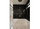 Modern shower featuring black tile, marble accents, and dual shower heads at 130 Nova Ln, Roswell, GA 30075