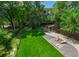 Lush backyard featuring a well-manicured lawn, patio with seating, and storage shed at 417 S Candler St, Decatur, GA 30030