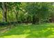 Expansive backyard with a manicured lawn bordered by a classic wooden fence and mature trees, creating a serene setting at 417 S Candler St, Decatur, GA 30030
