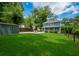 Charming backyard with lush lawn, patio featuring outdoor seating, storage shed, and home exterior at 417 S Candler St, Decatur, GA 30030