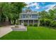 Beautiful home exterior featuring a lush lawn, outdoor seating, and a charming screened-in porch at 417 S Candler St, Decatur, GA 30030
