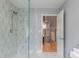 Bathroom with a sleek glassed shower, stylish tile, and an open doorway to a second-floor living space at 417 S Candler St, Decatur, GA 30030