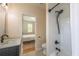 Bathroom featuring a modern shower/tub combo, sleek fixtures, and a view into a bright and airy bedroom at 417 S Candler St, Decatur, GA 30030