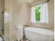 Bright bathroom with a garden tub, neutral walls, natural light, and custom fixtures at 417 S Candler St, Decatur, GA 30030