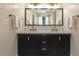 Bathroom featuring and sinks, neutral walls, a large mirror, and custom fixtures at 417 S Candler St, Decatur, GA 30030