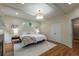 Cozy bedroom with a tray ceiling, recessed lights, bedside tables, and hardwood floors at 417 S Candler St, Decatur, GA 30030