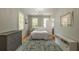 Cozy bedroom with a chandelier, hardwood floors, and lots of natural light from shuttered windows at 417 S Candler St, Decatur, GA 30030