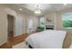 Bedroom featuring ensuite bath, a cozy fireplace, hardwood floors, and custom lighting at 417 S Candler St, Decatur, GA 30030