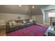 Bonus room featuring a large leather sectional and accent rug under a vaulted ceiling at 417 S Candler St, Decatur, GA 30030