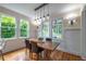 Bright dining room with a wooden table, stylish lighting, and large windows at 417 S Candler St, Decatur, GA 30030