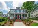 Inviting two-story home with a brick-accented front porch, classic architecture, and a well-manicured lawn at 417 S Candler St, Decatur, GA 30030
