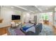 Spacious living area with coffered ceilings, hardwood floors, and a stylish blue patterned rug at 417 S Candler St, Decatur, GA 30030