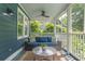 Relaxing screened-in porch with comfortable seating overlooking lush greenery at 417 S Candler St, Decatur, GA 30030