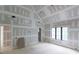 Bright, large bedroom showing vaulted ceiling, a doorway and large windows, during construction phase at 4608 Kings Down Rd, Atlanta, GA 30338