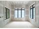 A bright bedroom under construction, featuring large windows that provide ample natural light and elegant trim work at 4608 Kings Down Rd, Atlanta, GA 30338