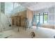 Under construction, a spacious living room with high ceilings, large windows, and staircase, bathed in natural light at 4608 Kings Down Rd, Atlanta, GA 30338