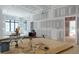 A spacious living room under construction with high ceilings, modern lighting, and a neutral color palette at 4608 Kings Down Rd, Atlanta, GA 30338