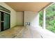 Covered patio with modern fireplace, wood ceilings, and sliding doors to the yard, offering a serene outdoor living space at 4608 Kings Down Rd, Atlanta, GA 30338