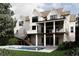A multi-level white home showcases a pool, a covered patio and a staircase in a lush, green backyard at 4608 Kings Down Rd, Atlanta, GA 30338