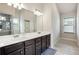 Bright bathroom with double sinks and a large mirror at 106 Logan Pass Dr, Loganville, GA 30052