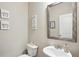 Powder room with a pedestal sink, toilet, and decor at 106 Logan Pass Dr, Loganville, GA 30052