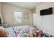 Bedroom with patterned bedspread and a mounted television at 106 Logan Pass Dr, Loganville, GA 30052