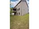 The exterior elevation reveals a walk out basement, multiple windows, and a deck overlooking the backyard at 106 Logan Pass Dr, Loganville, GA 30052