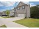View of the front yard, driveway, and entrance, highlighting the property's inviting curb appeal and architecture at 106 Logan Pass Dr, Loganville, GA 30052