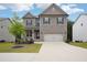 Charming two-story home featuring a brick and siding exterior with a well-manicured front yard and a two-car garage at 106 Logan Pass Dr, Loganville, GA 30052