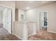 Hallway featuring multiple doors, carpet, and natural light at 106 Logan Pass Dr, Loganville, GA 30052